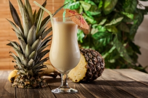 Pina Colada over wooden background deadhead COCKTAIL Coco Pina Colada